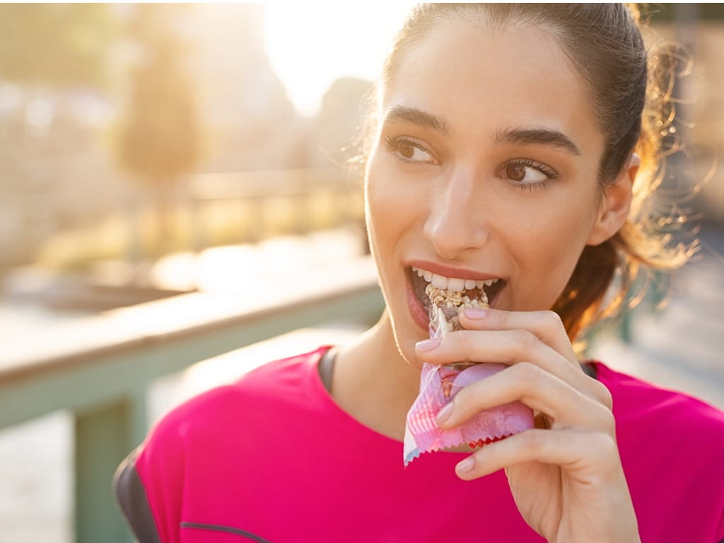 woman eating a protein bar
